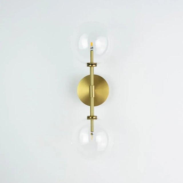 Dawn dual brass wall sconce by schwung dimensions: w 19 x d 15 x h 47.5 cm materials: natural brass, hand blown glass...