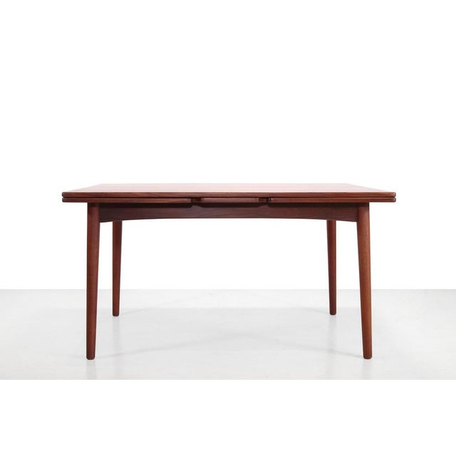 Vintage teak dining table that can be extended on two sides. The extra leaves are beautifully integrated into the design,...
