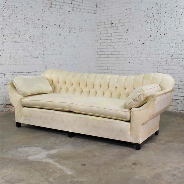 Fabulous vintage Art Deco or Hollywood Regency sofa with a tufted back and concave pillowed arms. The sofa is in solid...