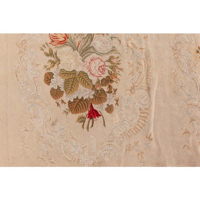 A masterful example of late 19th-century French textile artistry, this antique needlepoint rug from the 1880s is a vibrant...