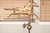 A decorative vintage copper galloping horse weathervane mounted on heavy black iron stand with brass directional arms...