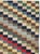 This mid-20th-century Turkish Anatolian rug presents a vibrant checkerboard composition built from small rectangular...