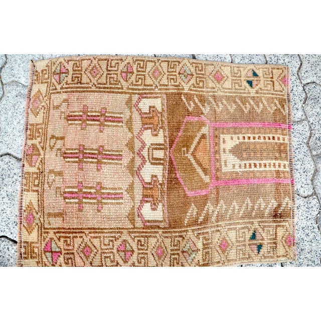 This is a vintage Turkish Oushak rug from the 1960s. The piece was hand-knotted.