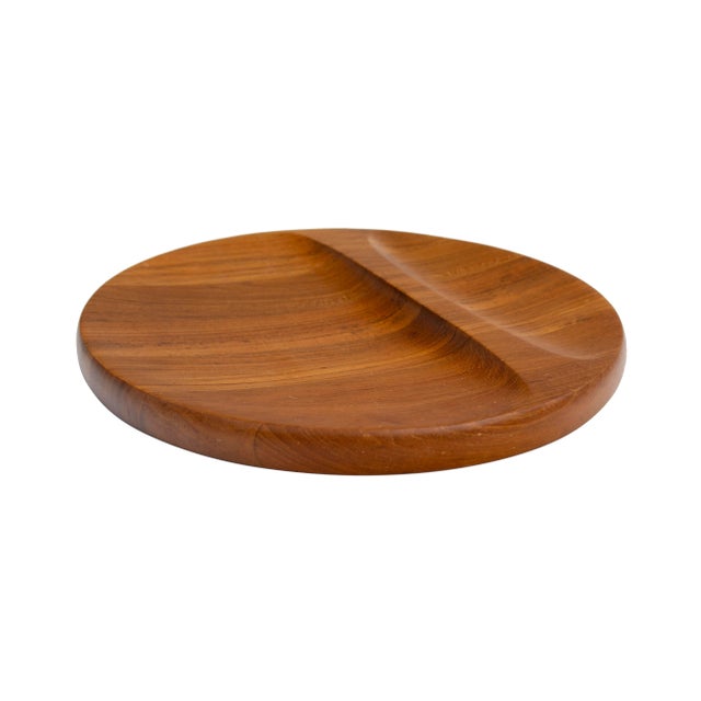 Denmark, 1960s Sculpted solid teak tray, serving dish, or platter by Nissen. This serving or display piece is round and...