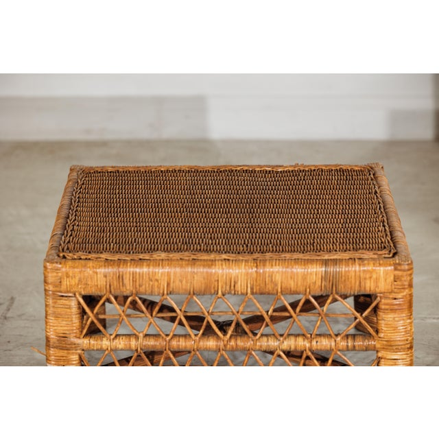 This vintage rattan coffee table offers a breezy, textural presence with its low rectangular form and handwoven...
