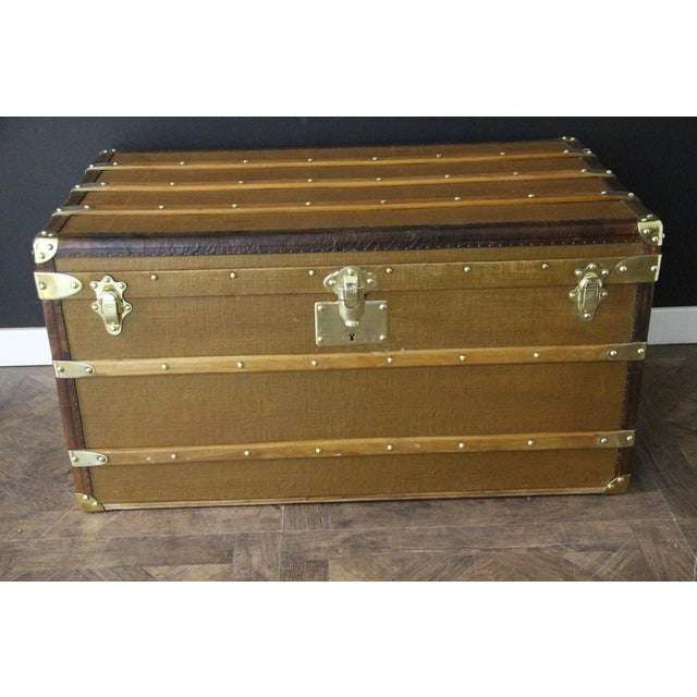 This magnificent Goyard trunk is made of caramel-colored canvas with chocolate brown leather trim and side handles. It...