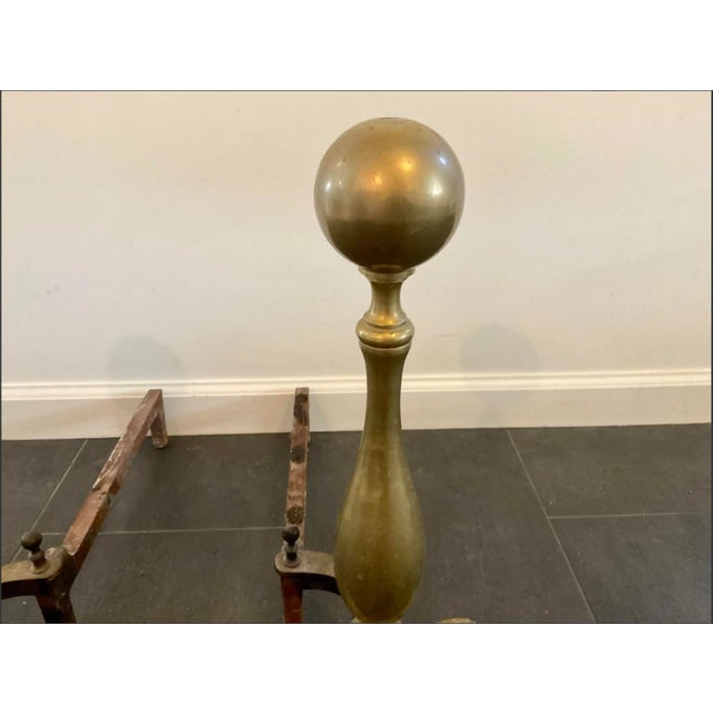 A pair of vintage brass andirons with classic cannonball finials, shaped standards and claw feet. Product Information:...