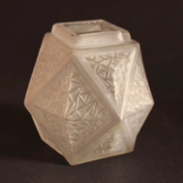 This Art Deco vase from a French manufacturer features geometric motifs. It consists of etched matte glass.