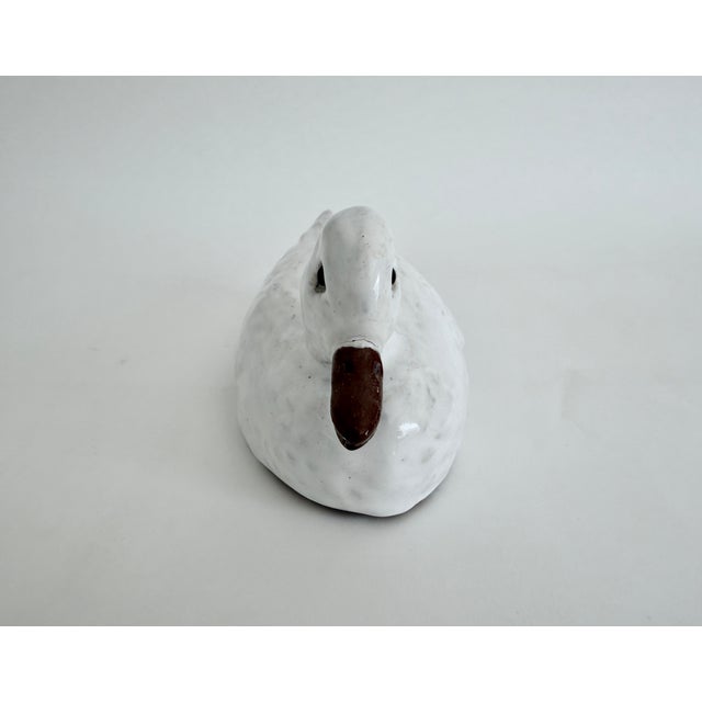 Antique French "faience" white glazed terracotta duck sculpture with glass eyes. The imprint "Modele Depose" indicates it...