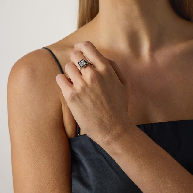 This striking Art Deco inspired square target ring captures the bold geometry and refined contrast that define the glamour...