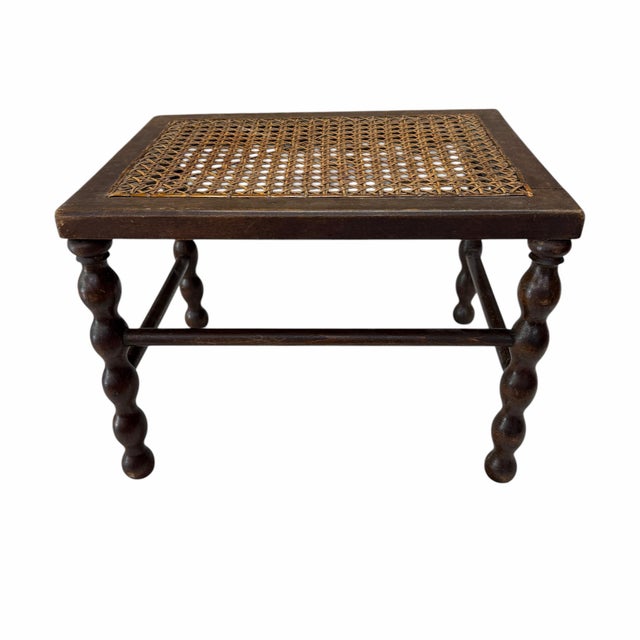 Antique walnut and cane footstool or display plant stand featuring spool / bobbin legs. Construction is all joinery no...
