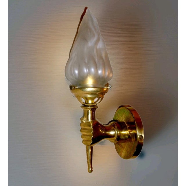 1950's French Regency Bronze Hand Torch Wall Sconce with Art Glass Flame Shade. Stunning statement lighting.