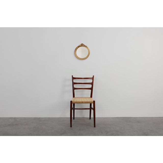 This elegant oval giltwood mirror embodies mid‑20th‑century Rococo revival craftsmanship, distinguished by its carved...