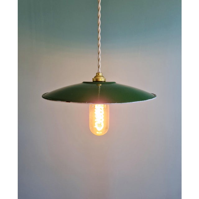 Mid-20th-century industrial pendant light in green enameled sheet metal. Seven pieces are available. Each pendant light...