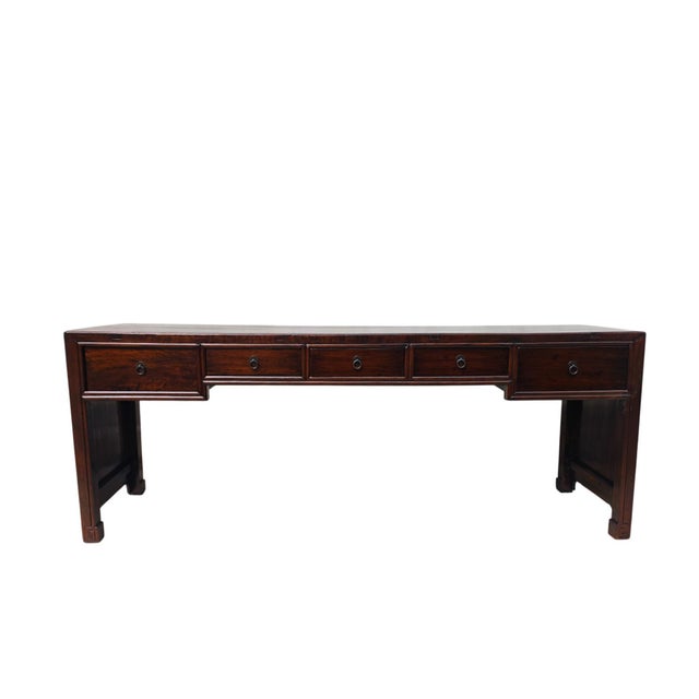 This a grand, extra-wide writing desk is made from solid wood and features a long, plain desktop surface measuring over 90...