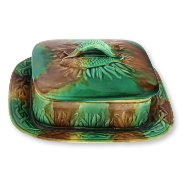 Antique English majolica sardine box dating to the late 19th century, decorated in rich green and brown glazes with a...