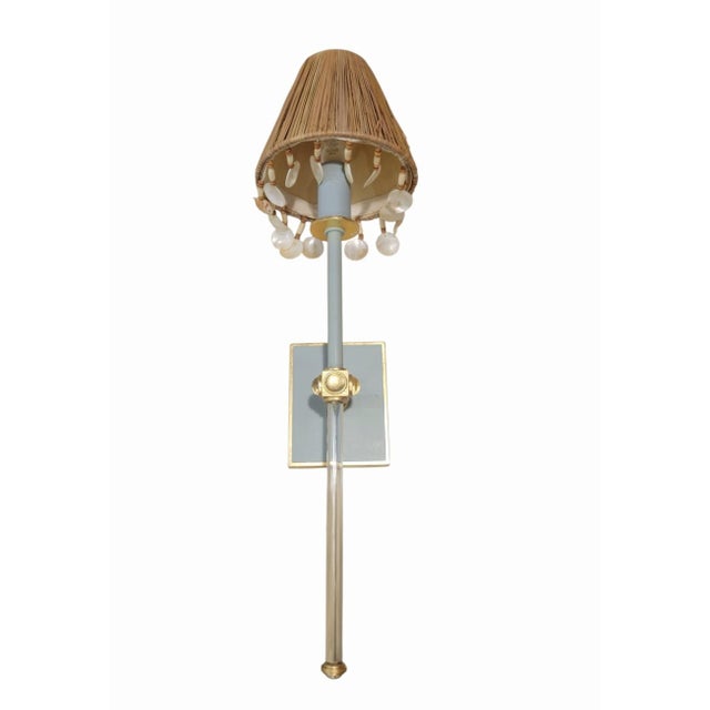 This is a Visual Comfort single light soft blue and crystal rod wall sconce lamp. The fixture features a soft blue...