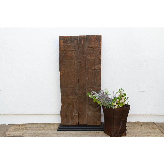 From the Nupe people of the Niger River region near Bida, Nigeria, this door is built from three narrow, independently...