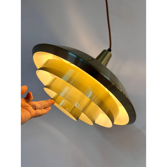 This Danish slatted lamp is a shining example of Scandinavian lighting design from the mid-century era. Composed of four...