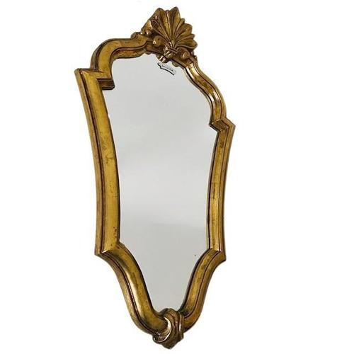 Baroque mid-century crest mirror with a classic gold-leaf gilt frame made of wood from the 1950s. This vintage mirror is...