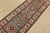 A tribal Caucasian Kazak runner hand-knotted with fine wool on a cotton foundation. This rug features a row of medallions...