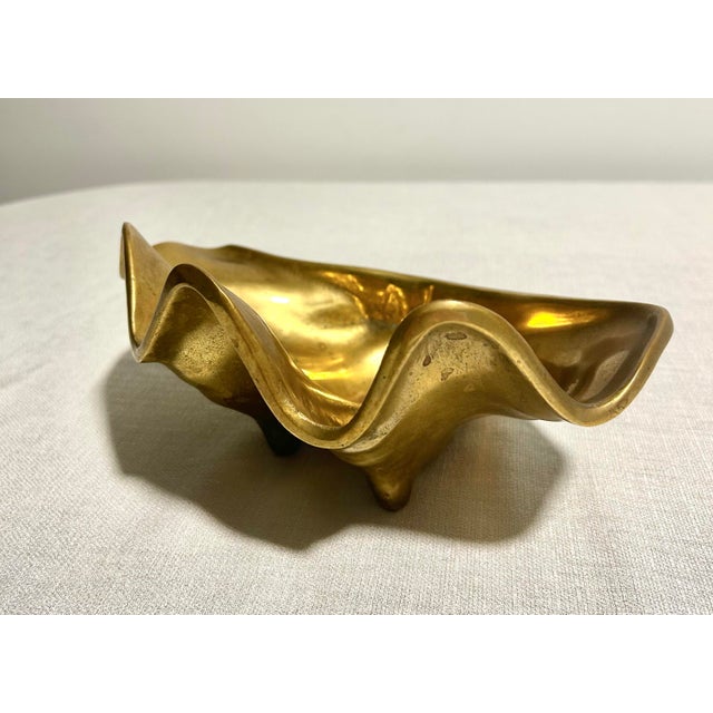 Sleek and sculptural in form, this MCM Gump’s Made in Hong Kong solid brass seashell catchall brings a touch of coastal...