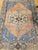 This vintage Turkish Oushak area rug from the second quarter of the 20th century features a striking open medallion design...