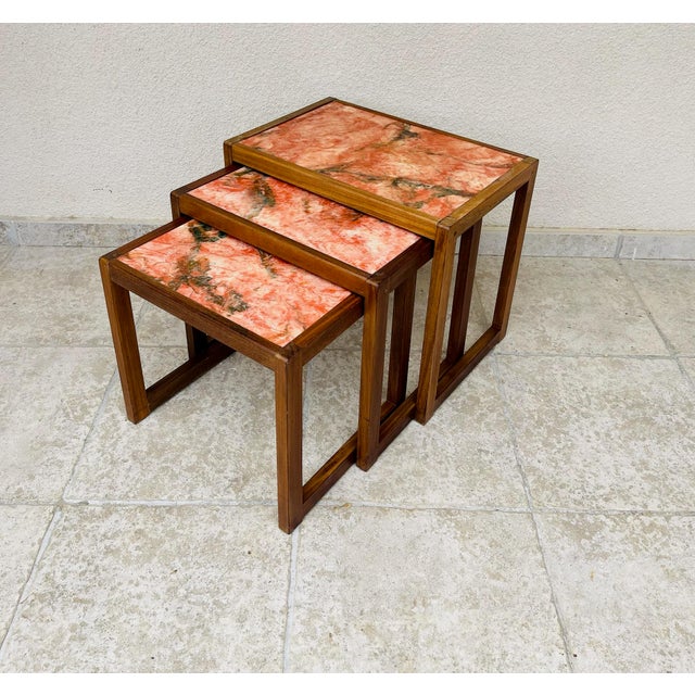 Set of three vintage nesting tables, combining the natural charm of solid wood with the elegance of marble. each table...