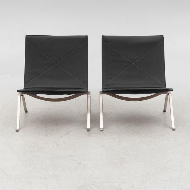 A pair of PK-22 lounge chairs designed by Poul Kjærholm and produced by Fritz Hansen in Denmark. These have that very...