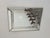 An elegant vintage wall mirror dating from the 1980s, featuring a beautifully architectural frame composed of wide beveled...
