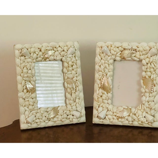 White Sea shells with pearl shells encrusted photo frames . Great for weddings.
