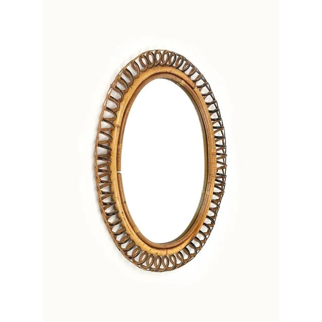 Mid-Century beautiful oval wall mirror in bamboo and rattan in the style of Italian design Franco Albini. Made in Italy in...