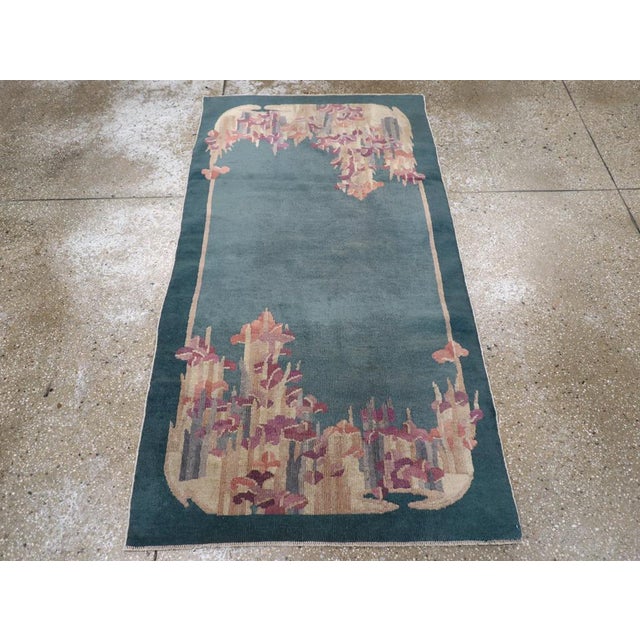 This mid-20th century Chinese Art Deco rug, features a striking asymmetrical design that embodies the elegance and...