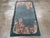 This mid-20th century Chinese Art Deco rug, features a striking asymmetrical design that embodies the elegance and...