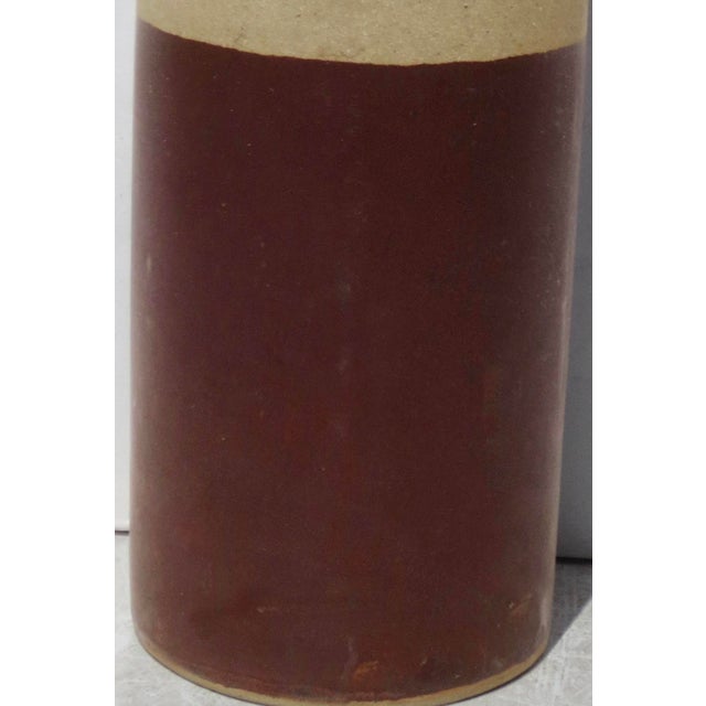 Stoneware cylinder in MCM style, glazed in a 3-color pattern with a stippled tan glaze, raw stoneware surface, and deep...