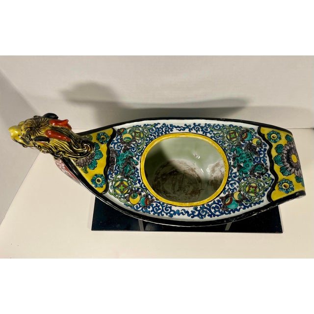 A striking vintage hand-painted porcelain cache pot featuring an elegant dragon-form handle and richly detailed floral and...
