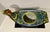 A striking vintage hand-painted porcelain cache pot featuring an elegant dragon-form handle and richly detailed floral and...