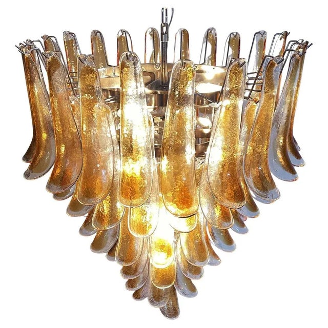 Italian vintage Murano chandelier made by 75 glass petals transparent with an amber spot inside, nickel metal structure....