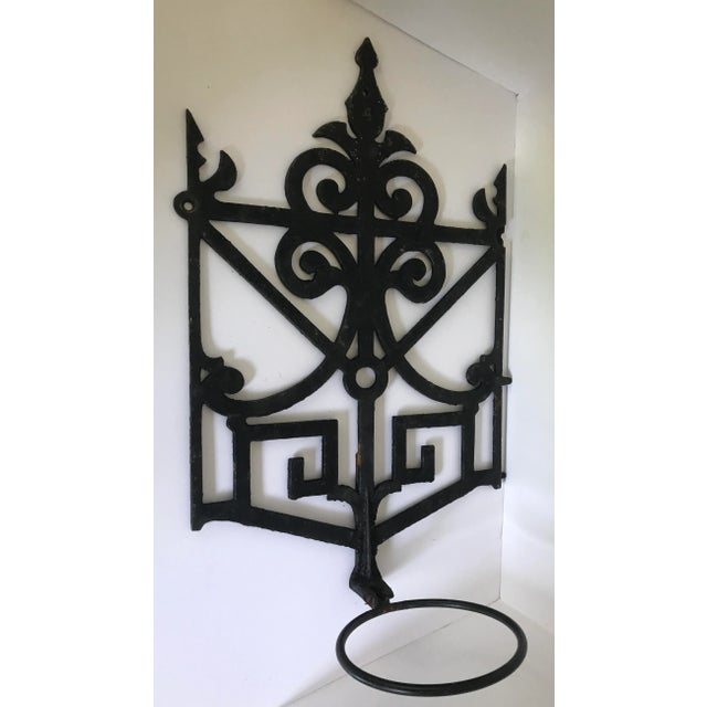 Hand cast Iron work which has been repuposed into a wall hanging plant stand. Diameter of iron ring is 6 inches. Great...