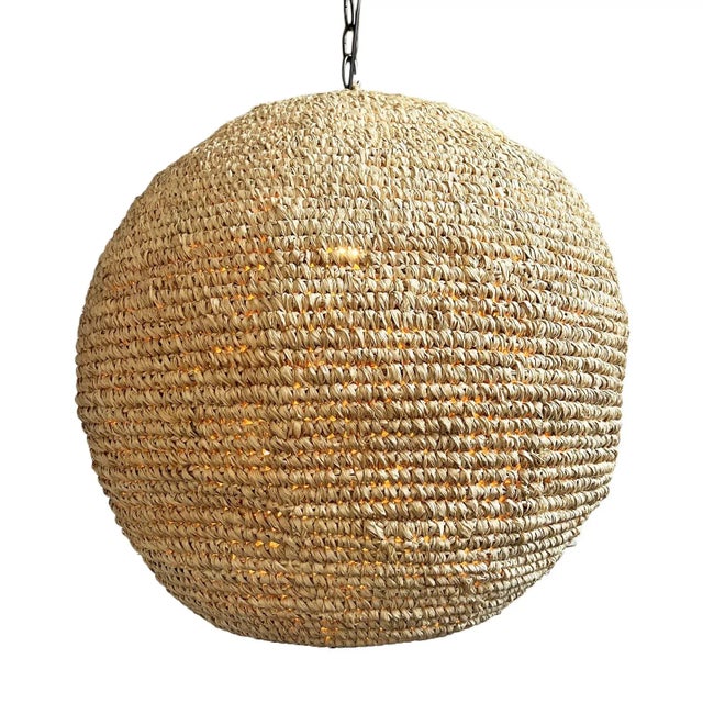 Hand woven light blond raffia grass globe pendant light. Fresh and relaxed contemporary coastal style. Each lantern may...
