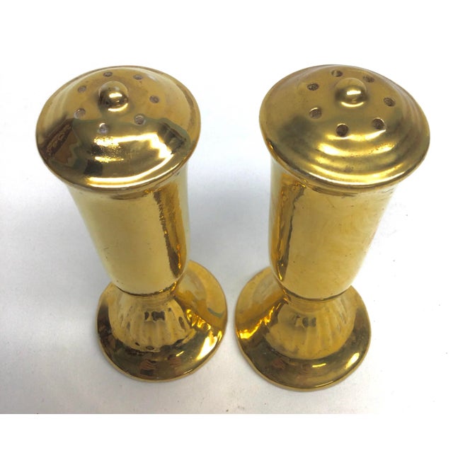 Lovely set of bright vivid gold salt and pepper shakers. These are in vintage condition with the cork missing on one and...