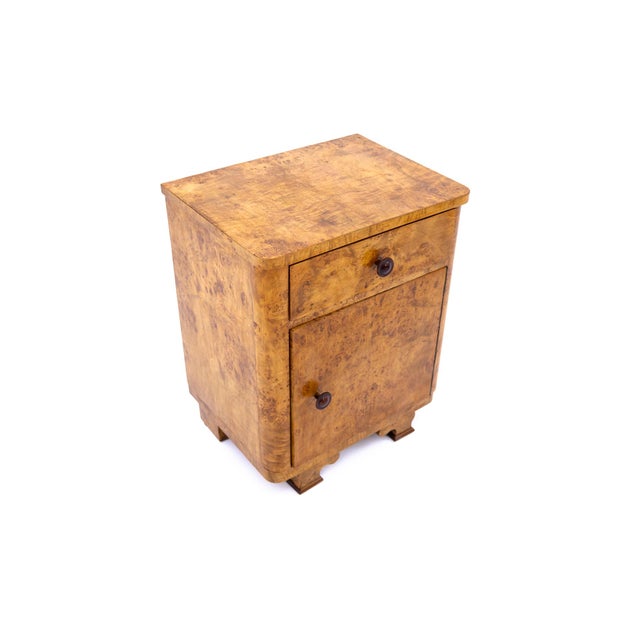 A pair of exceptional Art Deco style bedside tables from 1950s Poland. Crafted from high-quality walnut burl veneer,...