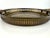 Vintage brass serving tray with a pierced gallery rim and decorative cast handles. The wide circular form is accented by...