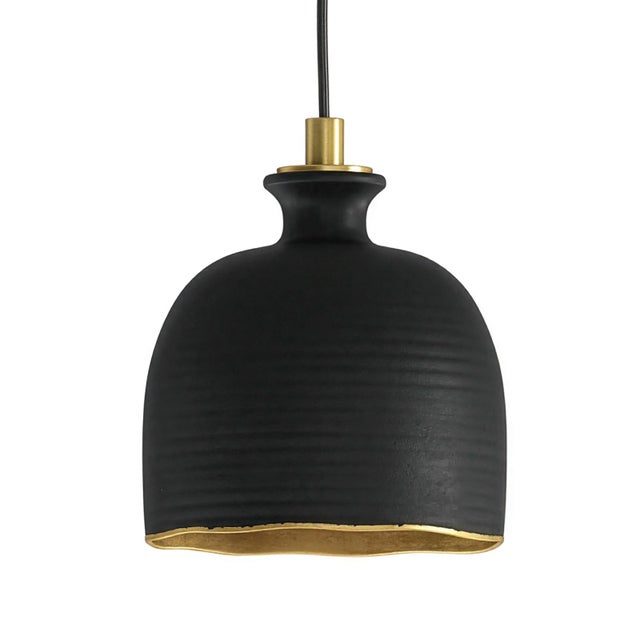Crafted of ceramic with brass accents, the Bianca ceramic pendant makes a striking statement overhead with a radiant gold...