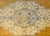 A vintage Turkish Oushak rug with a beautiful diamond medallion amidst a field of flowers woven in gold, indigo, brown,...