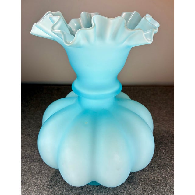 Pale blue cased glass featuring a ruffled, crimped rim, and a distinctive ribbed design.
