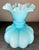 Pale blue cased glass featuring a ruffled, crimped rim, and a distinctive ribbed design.