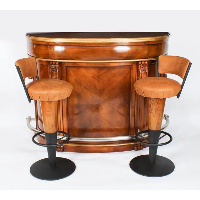 This is a fabulous antique pair of Art Deco revolving bar stools that are made of walnut with a black iron base,...