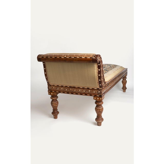 Antique Anglo-Indian chaise lounge, late 19th century, in carved hardwood with intricate inlaid geometric and floral...