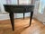 Elegant vintage Mersman side table featuring a classic oval-round silhouette, fluted detailing, tapered legs, and original...